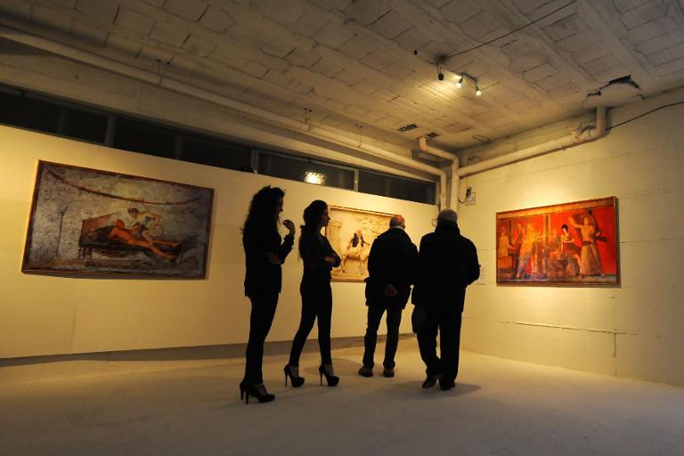 Visitors look at artworks at the opening of the ErotiCAM_Secret Room II exhibition, censored by the Italian culture ministry at the Casoria Contemporary Art Museum near Naples on November 28, 2013
